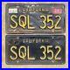 1963_California_license_plate_pair_SQL_352_yellow_on_black_embossed_1964_garage_01_banu