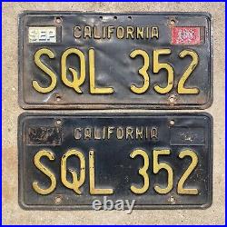1963 California license plate pair SQL 352 yellow on black embossed 1964 garage