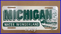 Michigan Water Wonderland booster license plate front 1950s white on green brass
