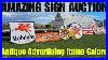 Searching_For_Deals_At_An_Estate_Auction_Full_Of_Vintage_Advertising_Signs_01_zc