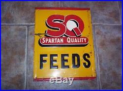 Vintage SQ Spartan Quality Feeds Embossed Metal Sign Old Farm Seed Advertising