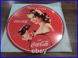 Vintage girl drinking Coca-Cola metal sign